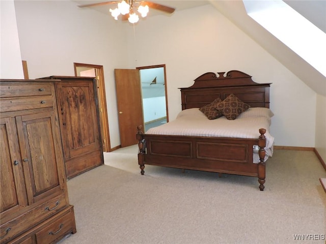 carpeted bedroom with ceiling fan and lofted ceiling