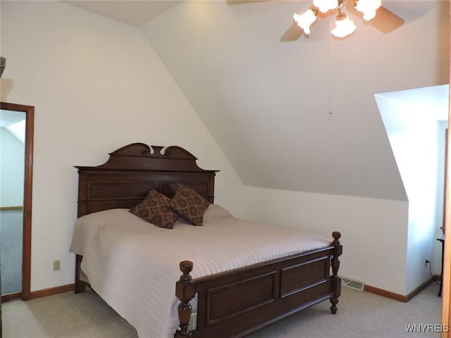 bedroom with ceiling fan, light colored carpet, and lofted ceiling