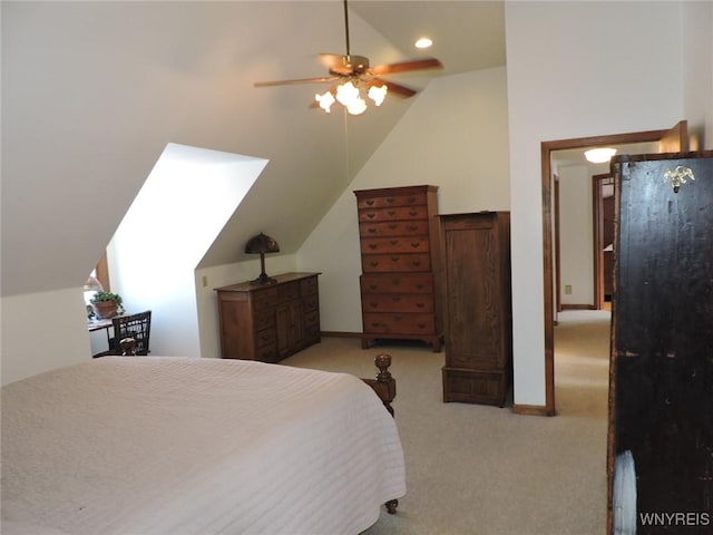 carpeted bedroom with ceiling fan and lofted ceiling with skylight