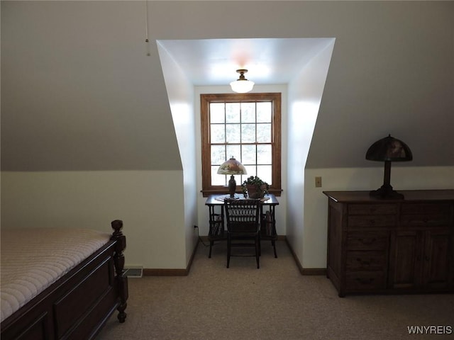 bedroom with light colored carpet and vaulted ceiling