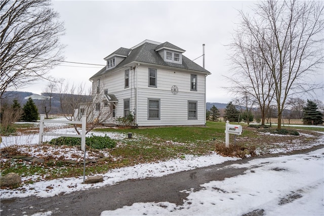 view of snow covered exterior featuring a lawn