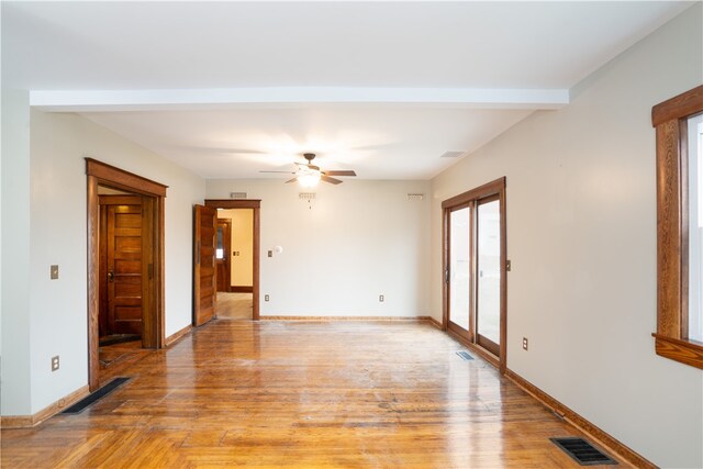 empty room with light wood-type flooring and ceiling fan