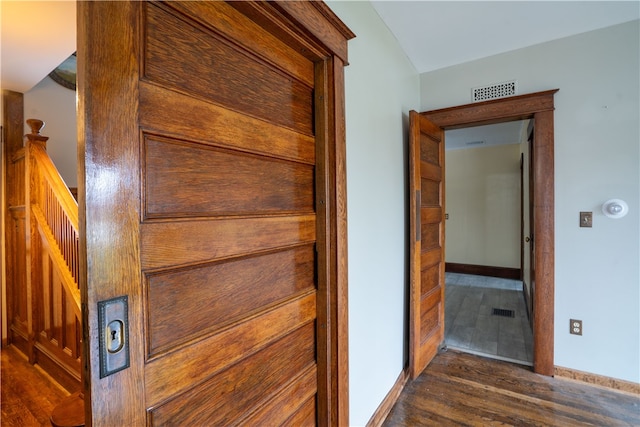 hallway with dark hardwood / wood-style floors