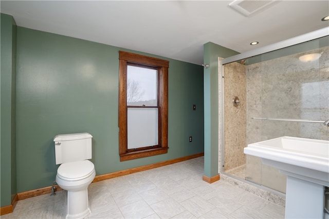 bathroom with tile patterned floors, sink, an enclosed shower, and toilet