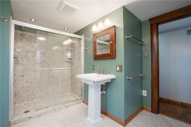 bathroom featuring tile patterned floors and a shower with shower door