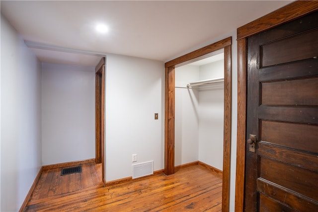 unfurnished bedroom featuring light wood-type flooring and a closet