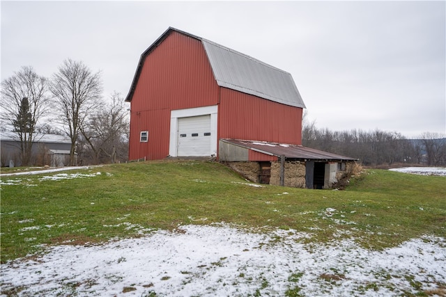 snow covered structure with a lawn