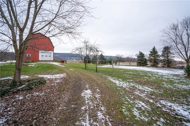 yard covered in snow featuring an outdoor structure