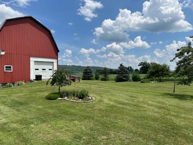 view of yard featuring an outbuilding and a garage