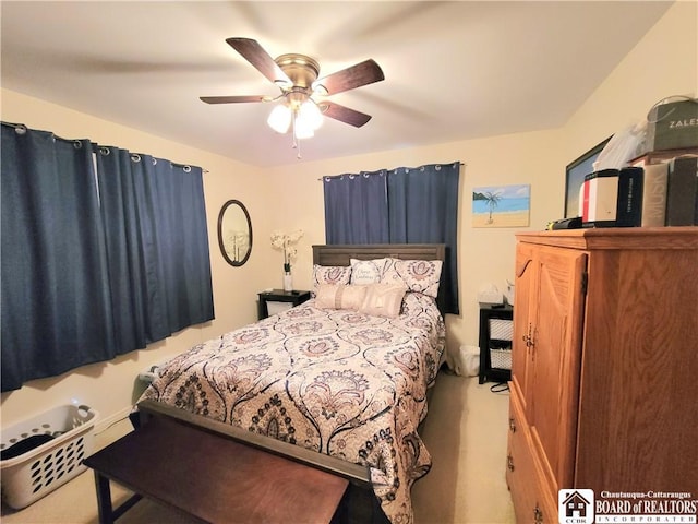 bedroom featuring ceiling fan and light carpet