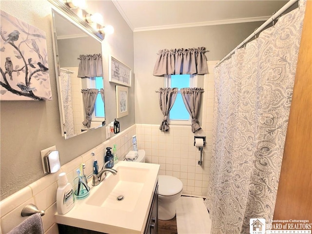 bathroom with vanity, toilet, tile walls, and ornamental molding