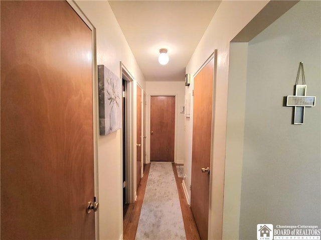 corridor with light hardwood / wood-style floors