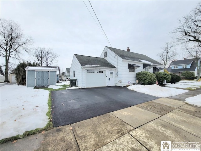 view of side of property with a garage and a storage shed