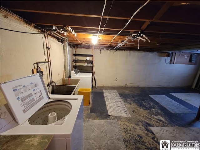 basement featuring sink and washing machine and clothes dryer