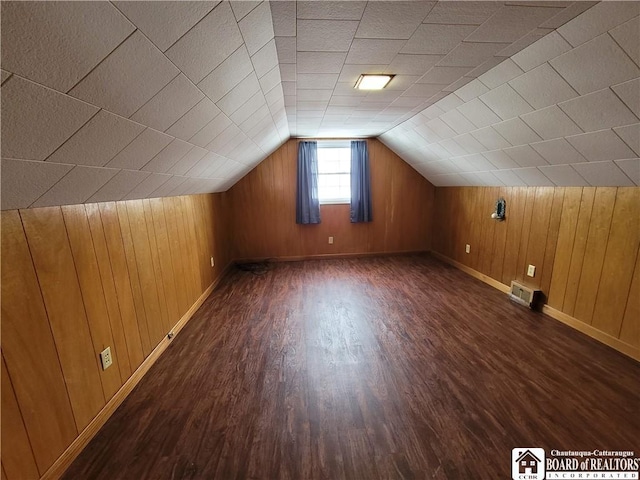 bonus room featuring dark wood-type flooring and lofted ceiling