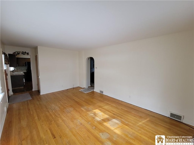 unfurnished room with hardwood / wood-style floors