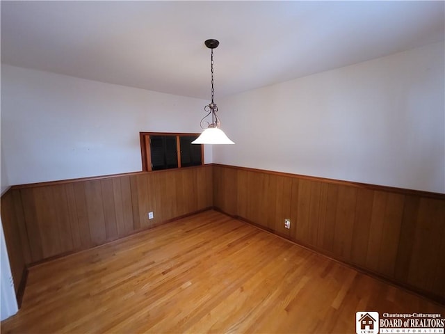 unfurnished dining area featuring light wood-type flooring