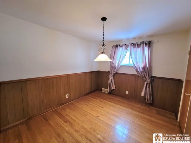 unfurnished dining area featuring light wood-type flooring