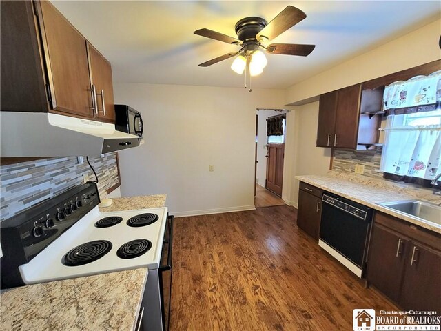 kitchen featuring dark brown cabinets, sink, tasteful backsplash, and black appliances