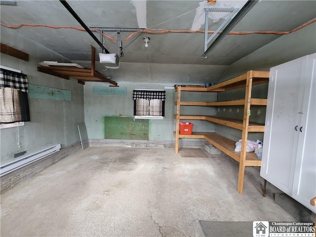 garage with a garage door opener and a baseboard radiator