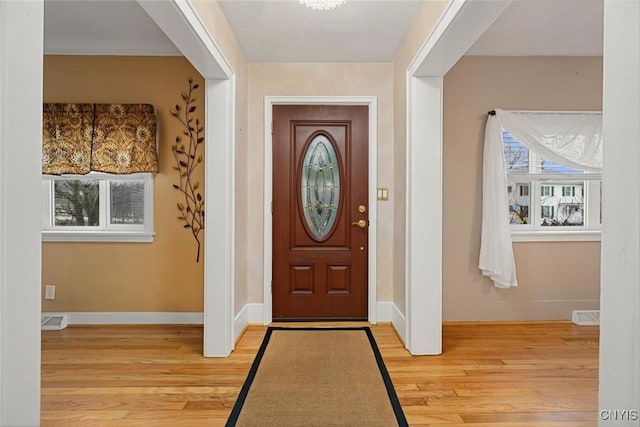 foyer entrance with plenty of natural light and light hardwood / wood-style floors