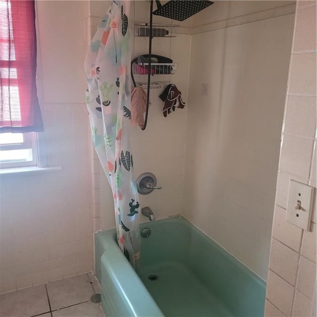 bathroom with tile walls, tile patterned flooring, and shower / tub combo