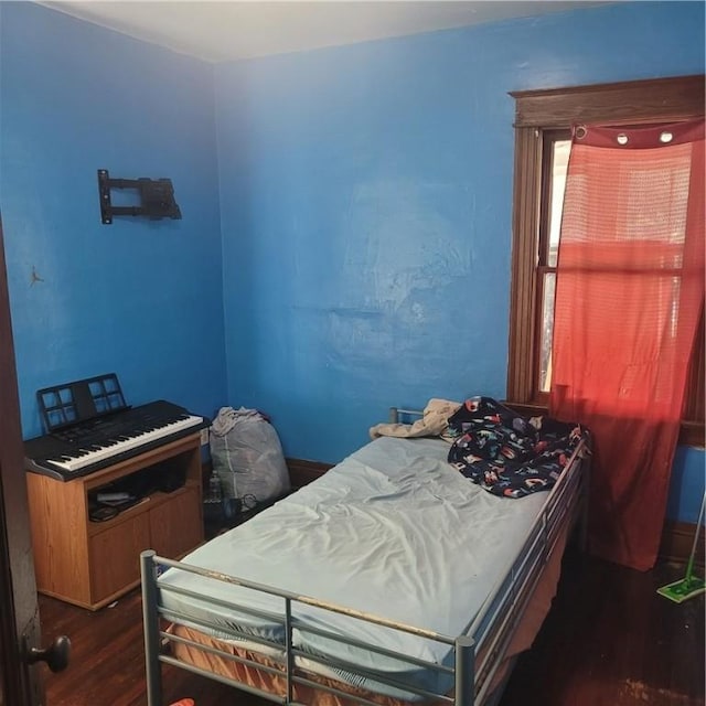 bedroom with dark wood-type flooring