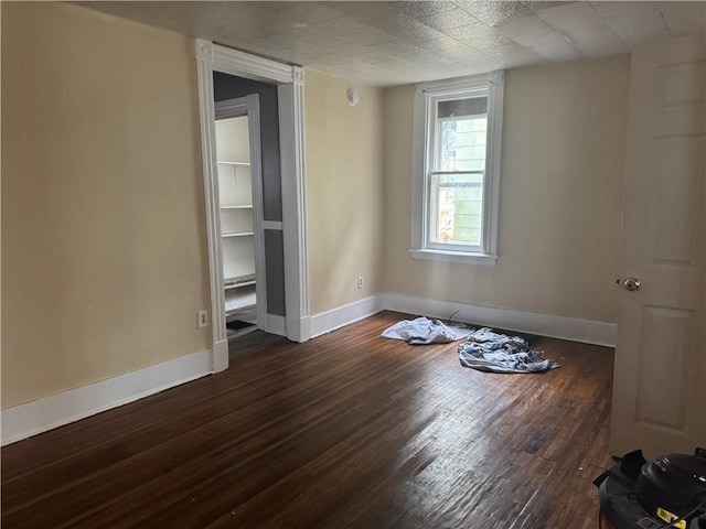 empty room with dark hardwood / wood-style floors