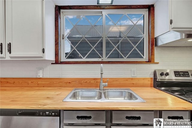 kitchen with decorative backsplash, appliances with stainless steel finishes, extractor fan, sink, and white cabinetry