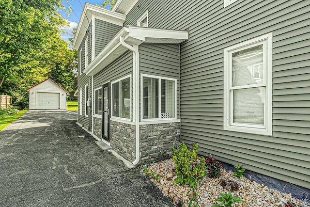 view of home's exterior featuring a garage and an outdoor structure