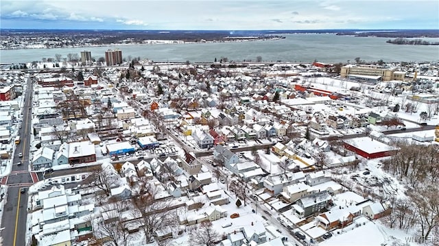 snowy aerial view featuring a water view