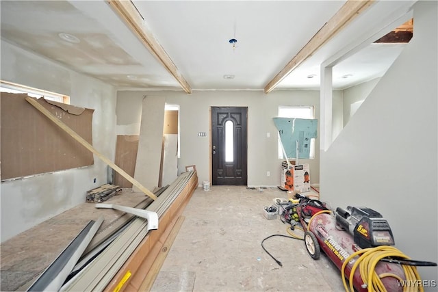 entrance foyer featuring beamed ceiling