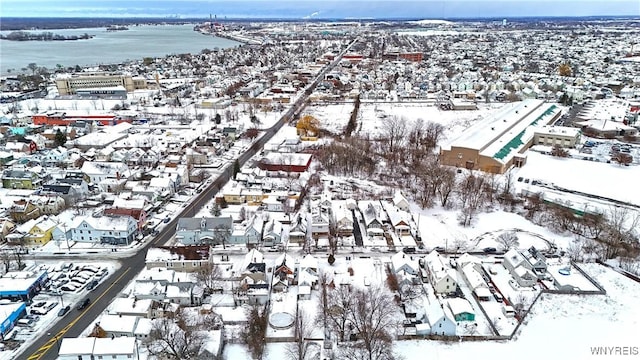 snowy aerial view featuring a water view