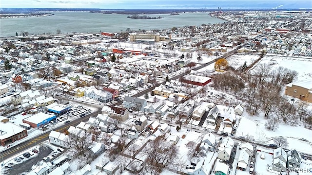 snowy aerial view featuring a water view