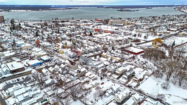 snowy aerial view featuring a water view