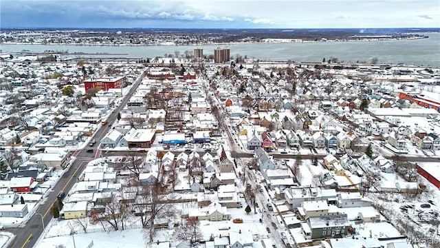 snowy aerial view with a water view