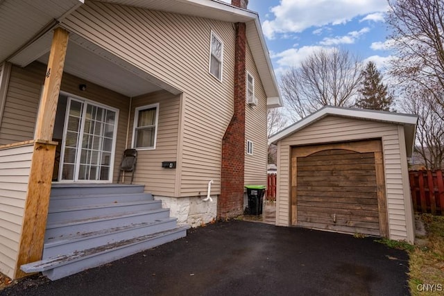 view of side of property featuring a garage and an outbuilding