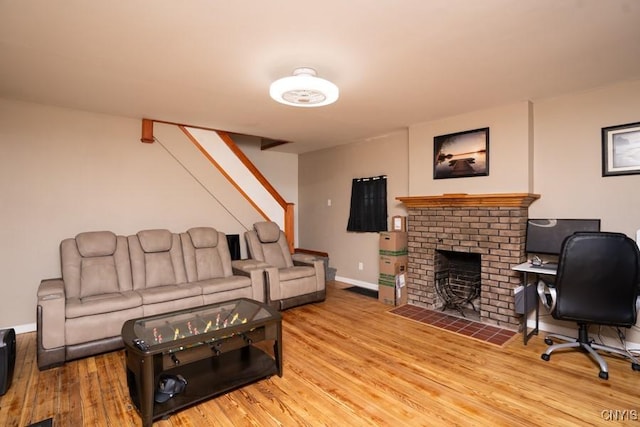 living room with a fireplace and wood-type flooring