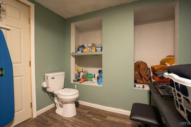 bathroom featuring hardwood / wood-style floors and toilet