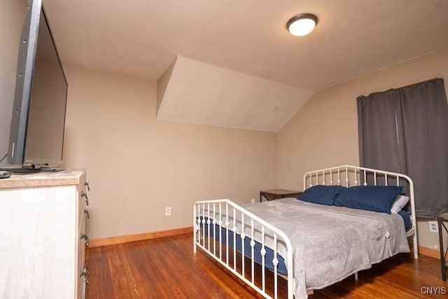 bedroom with dark hardwood / wood-style flooring and vaulted ceiling