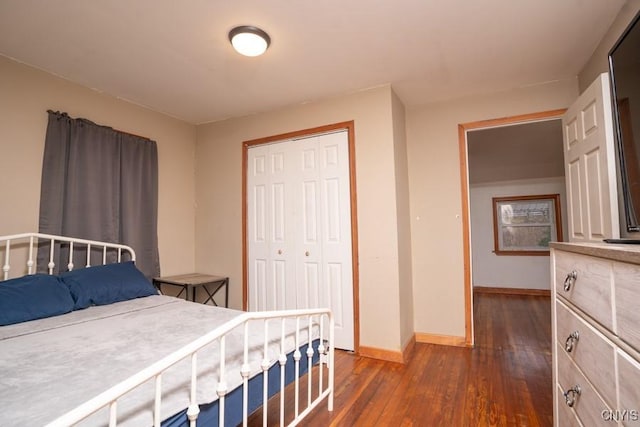 bedroom featuring dark hardwood / wood-style floors and a closet