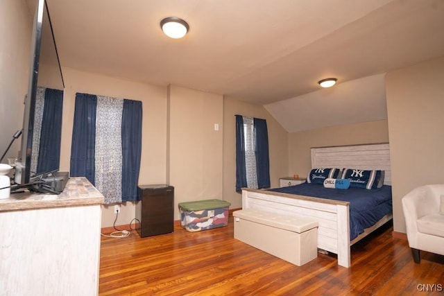 bedroom featuring dark wood-type flooring and lofted ceiling