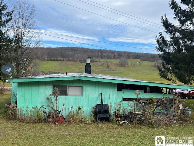 view of side of home with a lawn