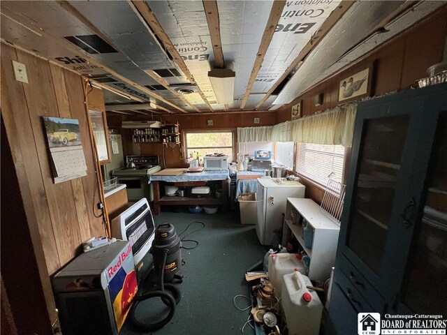 misc room with a workshop area and wooden walls