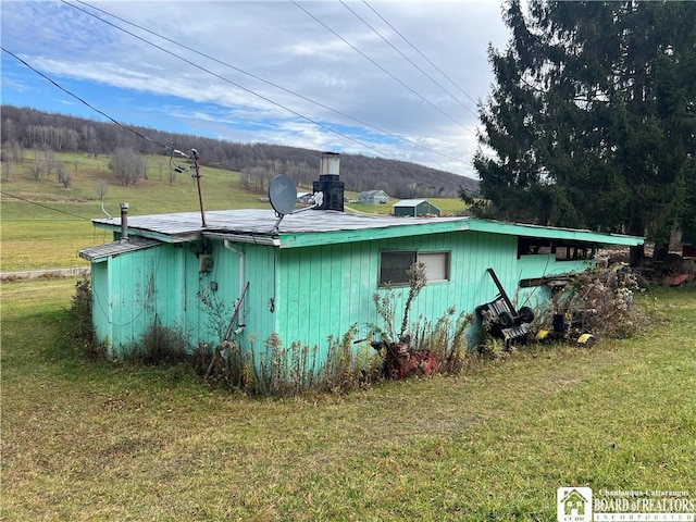 view of side of home featuring a yard