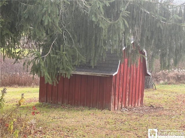 view of outbuilding with a lawn