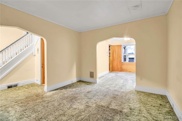 carpeted spare room with crown molding