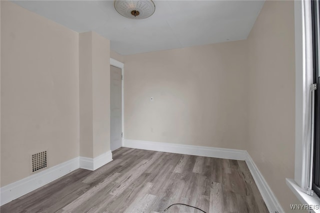 unfurnished room with light wood-type flooring