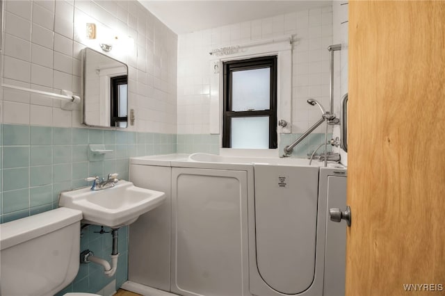 bathroom featuring decorative backsplash, toilet, tile walls, and sink