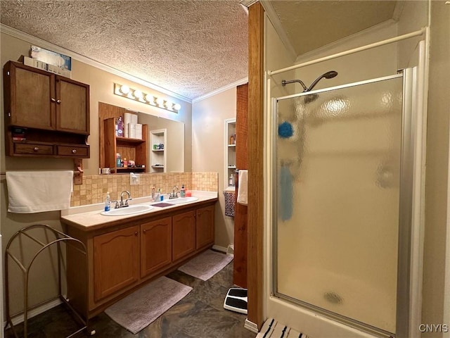 bathroom featuring decorative backsplash, vanity, a textured ceiling, crown molding, and a shower with shower door